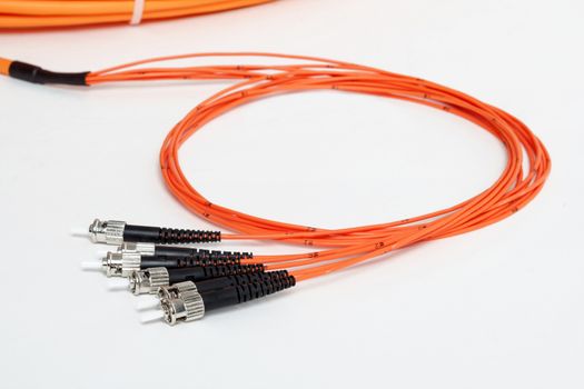 group of fiber optic ST connectors on orange patchcord 