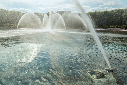 High pressured water gushing out of a pipes creating a beautiful water fountain