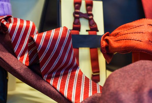 View of striped necktie and red gloves in the clothes shop
