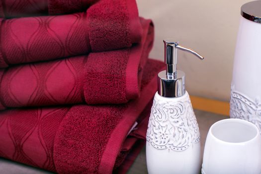 Stack of towels and liquid soap bottle