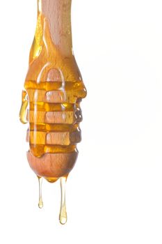 Honey dripping from a wooden honey dipper