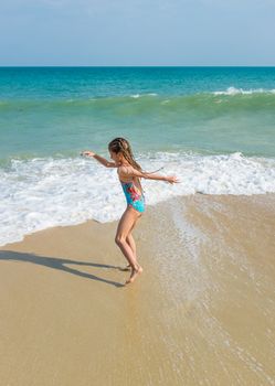 little girl on the sunny sea beach