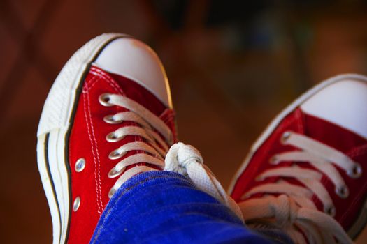 pair red sport shoes on foot