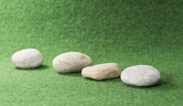 row of stones on green background
