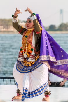 New York - Aug 20: A woman with costume and make-up performs a traditional indian dance at a cultural show on August 20, 2014 at Battery Park, New York, USA.
