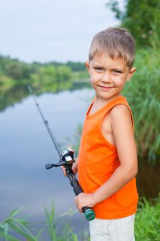 Summer vacation - Photo of little boy fishing on the river.