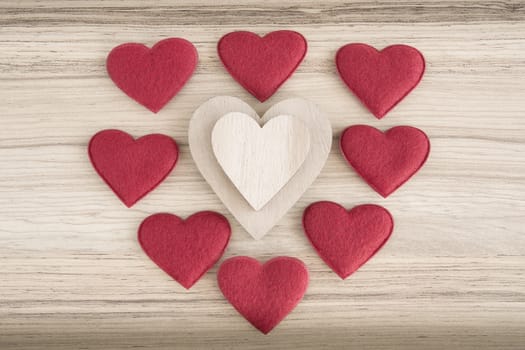 valentine's wooden and fabric hearts on a wooden background , valentine's day , day valentine postcard with space for text