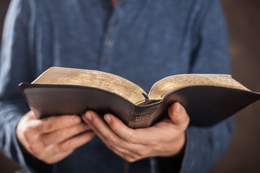 Man reading from the holy bible, close up