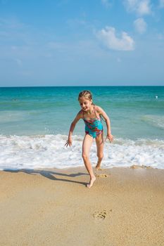 little girl on the sunny sea beach