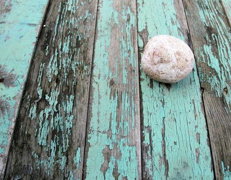 pebble on an old table with peeling paint