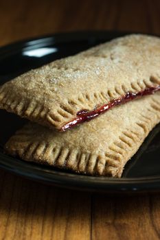 Whole wheat toaster pastries, lightly dusted with sugar crystals and filled with raspberry filling.