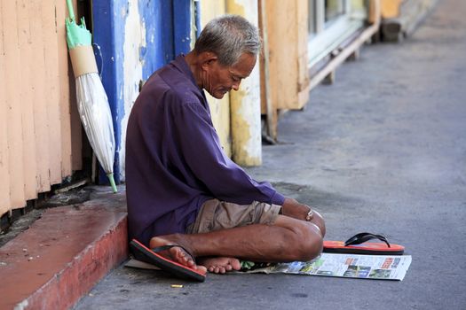 Kota Kinabalu, Malaysia - January 3, 2015: Homeless begger begging on street Kota Kinabalu in Borneo, Malaysia