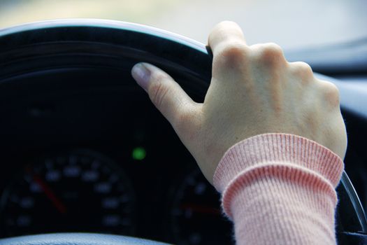 woman hand on wheel of car