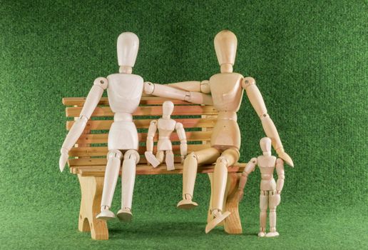 happy family with children in wooden play puppets on bench