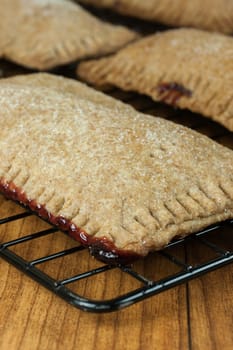 Whole wheat toaster pastries, lightly dusted with sugar crystals and filled with raspberry filling.