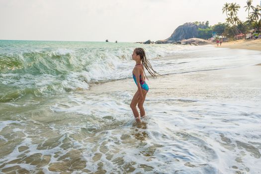 little girl on the sunny sea beach