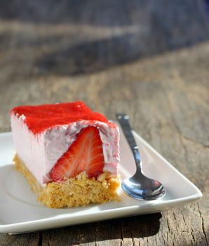 Fresh strawberry cheesecake on old wood