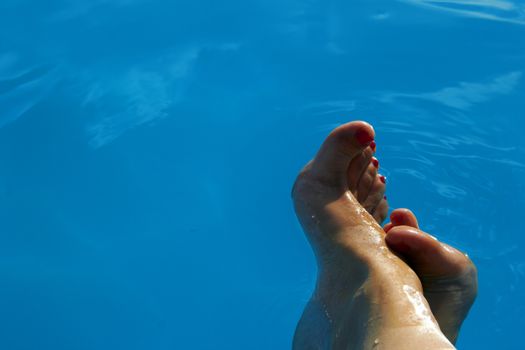 woman leg on blue water