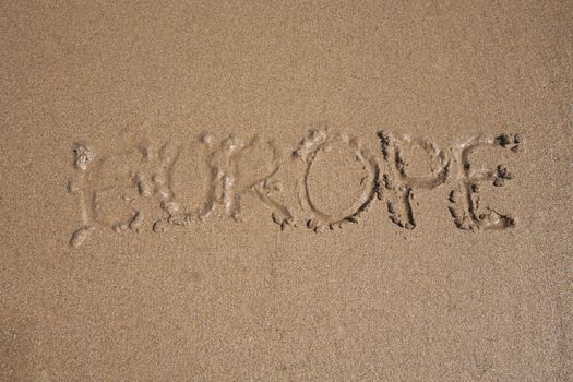 ocean water flood Europe word written on brown sand ground beach seashore
