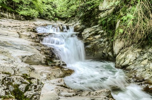 Beautiful waterfall in the Navarra forest. Amazing image with motion effect on the water. The picture is with high resolution and clean details for many manipulations.