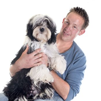 man and  tibetan terrier in front of white background