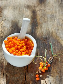 Seabuckthorn Berries in a Bowl with Leaves