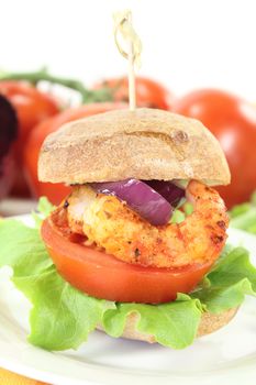 fresh delicious shrimp burger with tomatoes, red onion and lettuce