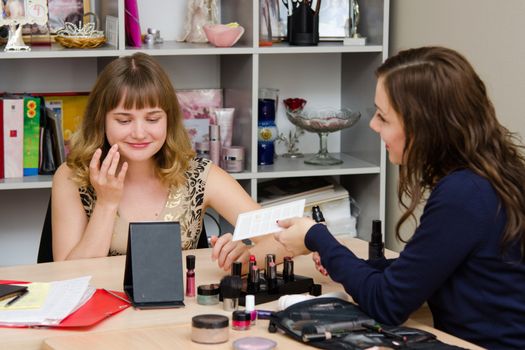 Beauty Consultants offers cosmetics client in the office