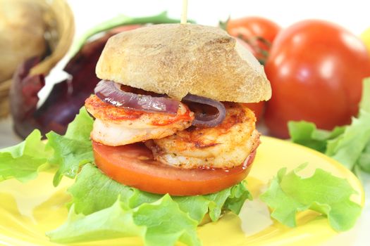 fresh healthy delicious shrimp burger with tomatoes, red onion and lettuce