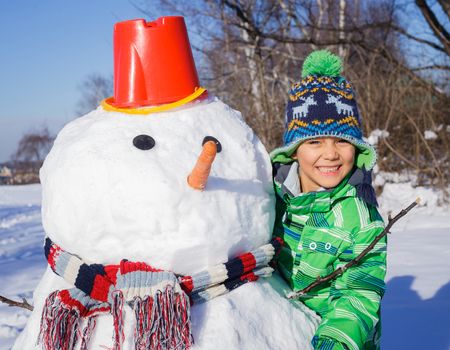 Winter, play, fun - Little boy making a snowman