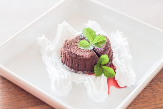 Chocolate lava with strawberry sauce, stock photo