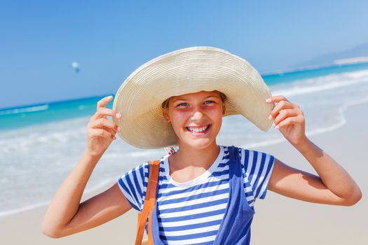 Summer vacation, lovely girl walking on the beach near water