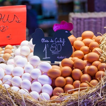 Interior of a busy food market, with detail of eggs group