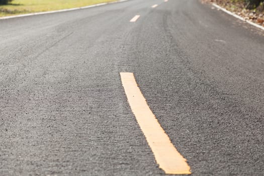 yellow curve on the road. The yellow curve on the road. Warned that the curve in this area