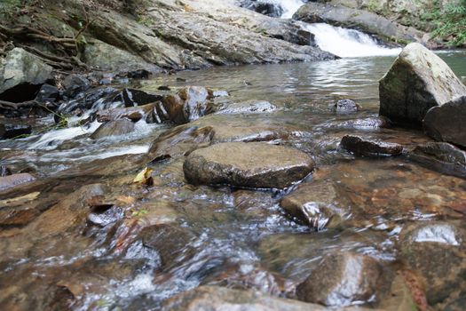 Waterfall that flows down from the mountains. Streams of water flowing down from the mountains. There is always a small stone waterfall.