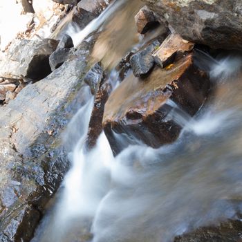 Waterfall that flows down from the mountains. Streams of water flowing down from the mountains. There is always a small stone waterfall.