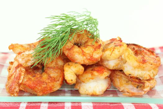 fried shrimp on a plate with lemon and dill