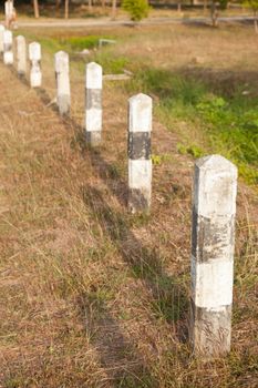 Cement beside the road. On the lawn edge of the road in a rural area.