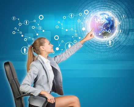 Businesswoman using virtual interface with Globe and network of person icons. Element of this image furnished by NASA