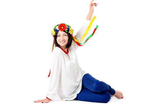 beautiful young brunette woman wearing national ukrainian clothes posing in studio on white background