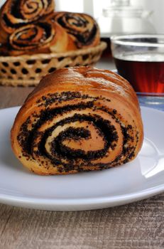 Freshly baked rolls with poppy seeds on a plate