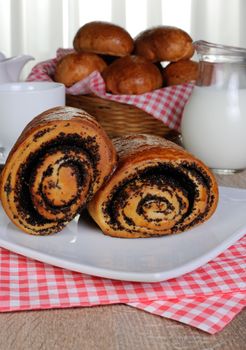 Freshly baked rolls with poppy seeds on a plate napkins