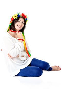 beautiful young brunette woman wearing national ukrainian clothes posing in studio on white background