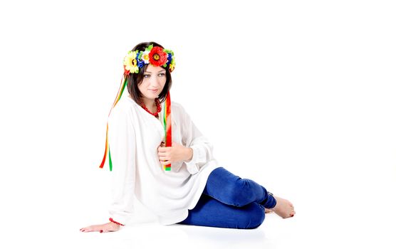 beautiful young brunette woman wearing national ukrainian clothes posing in studio on white background