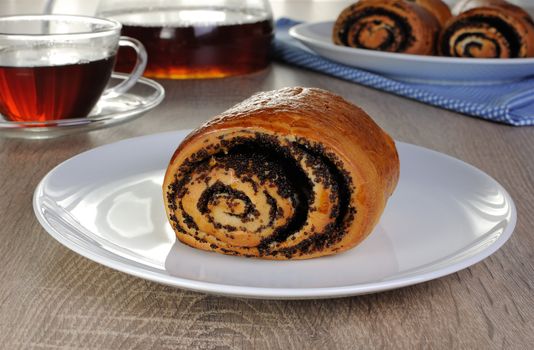 Freshly baked rolls with poppy seeds on a plate