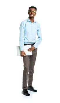 Happy african american college student standing with laptop on white background