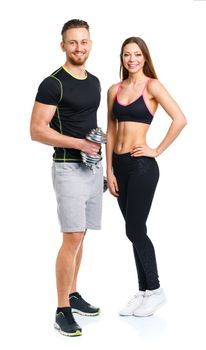 Sport couple - man and woman with dumbbells on the white background