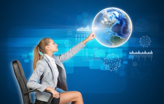 Businesswoman using virtual interface with Globe on blue background. Element of this image furnished by NASA