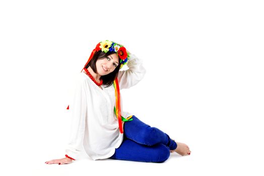 beautiful young brunette woman wearing national ukrainian clothes posing in studio on white background