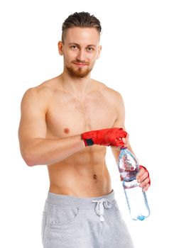 Sport attractive man wearing boxing bandages with bottle of water on the white background